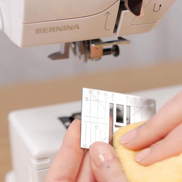 How to Clean and Oil Sewing Machines with a CB Hook - Hook Cleaning - remove the needle - remove the stitch plate - release bobbin case - bobbin case removed - dust out your machine - cleaning with a soft cloth - add the stitch plate